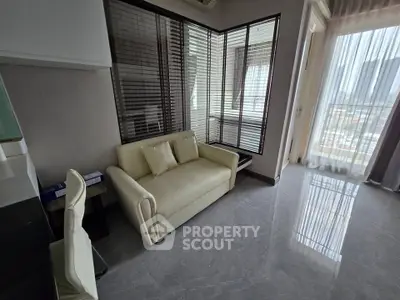 Modern living room with sleek design and city view, featuring a cozy sofa and elegant decor.