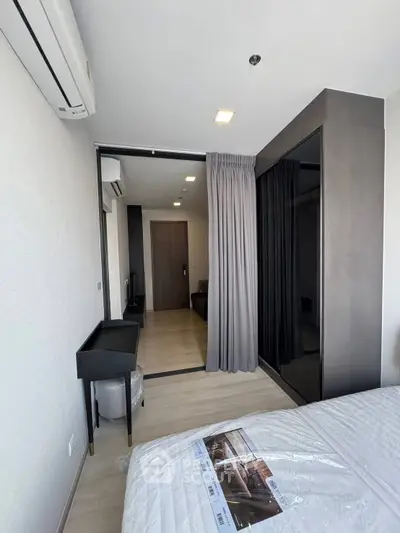 Modern bedroom with sleek design and large wardrobe in a stylish apartment.