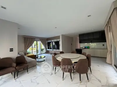 Spacious modern living room with elegant dining area and open kitchen layout