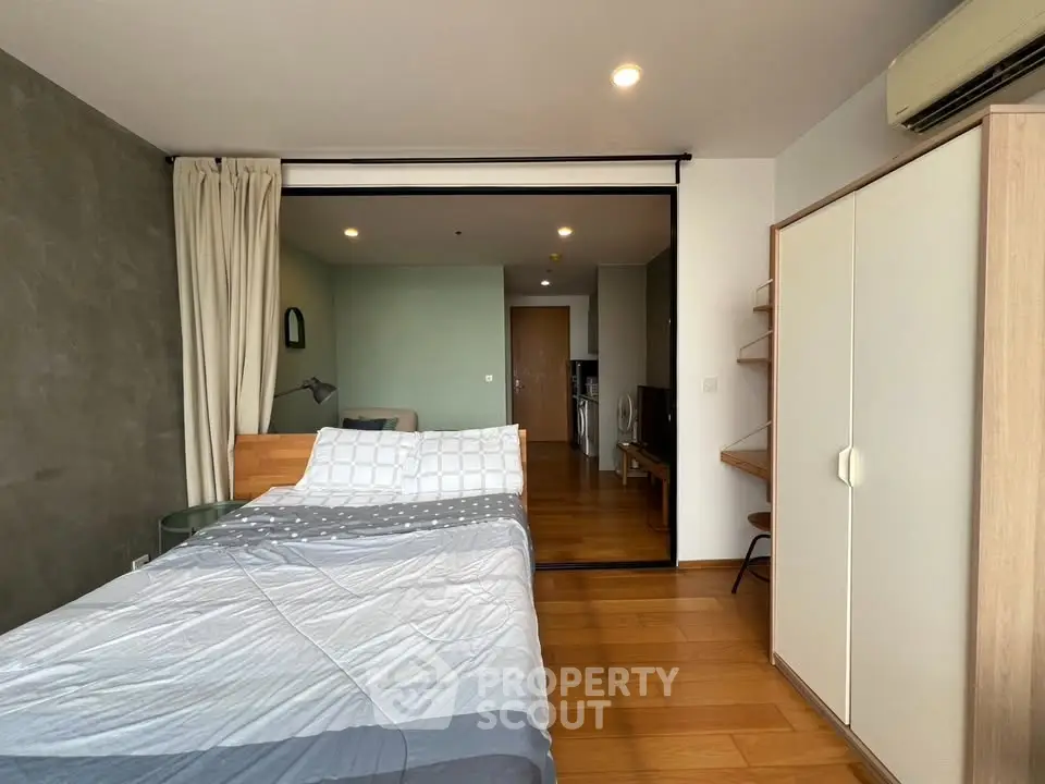 Modern bedroom with wooden flooring and stylish decor