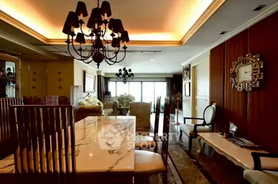 Luxurious dining room with elegant chandelier and marble table in upscale apartment