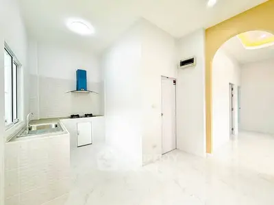 Bright modern kitchen with gas stove and sleek white design