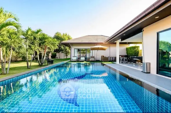 Luxurious villa with stunning pool and lush garden, perfect for relaxation and entertainment.