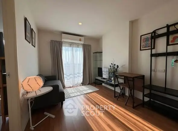 Charming living room with natural light, cozy sofa, and stylish decor, perfect for relaxation and entertainment.