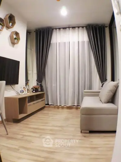 Modern living room with stylish decor and floor-to-ceiling curtains