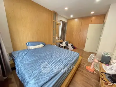 Spacious bedroom with wooden accents and ample storage space