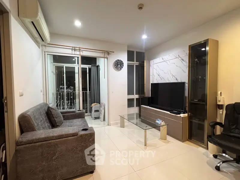 Modern living room with sleek furniture and large TV, featuring a stylish marble accent wall.