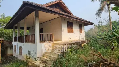 Charming rustic house with wooden accents and lush greenery, perfect for nature lovers seeking tranquility.