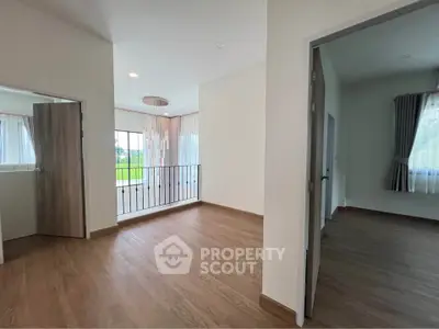 Spacious modern interior with wooden flooring and elegant lighting, perfect for a stylish home.