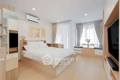 Modern bedroom with stylish decor and natural light