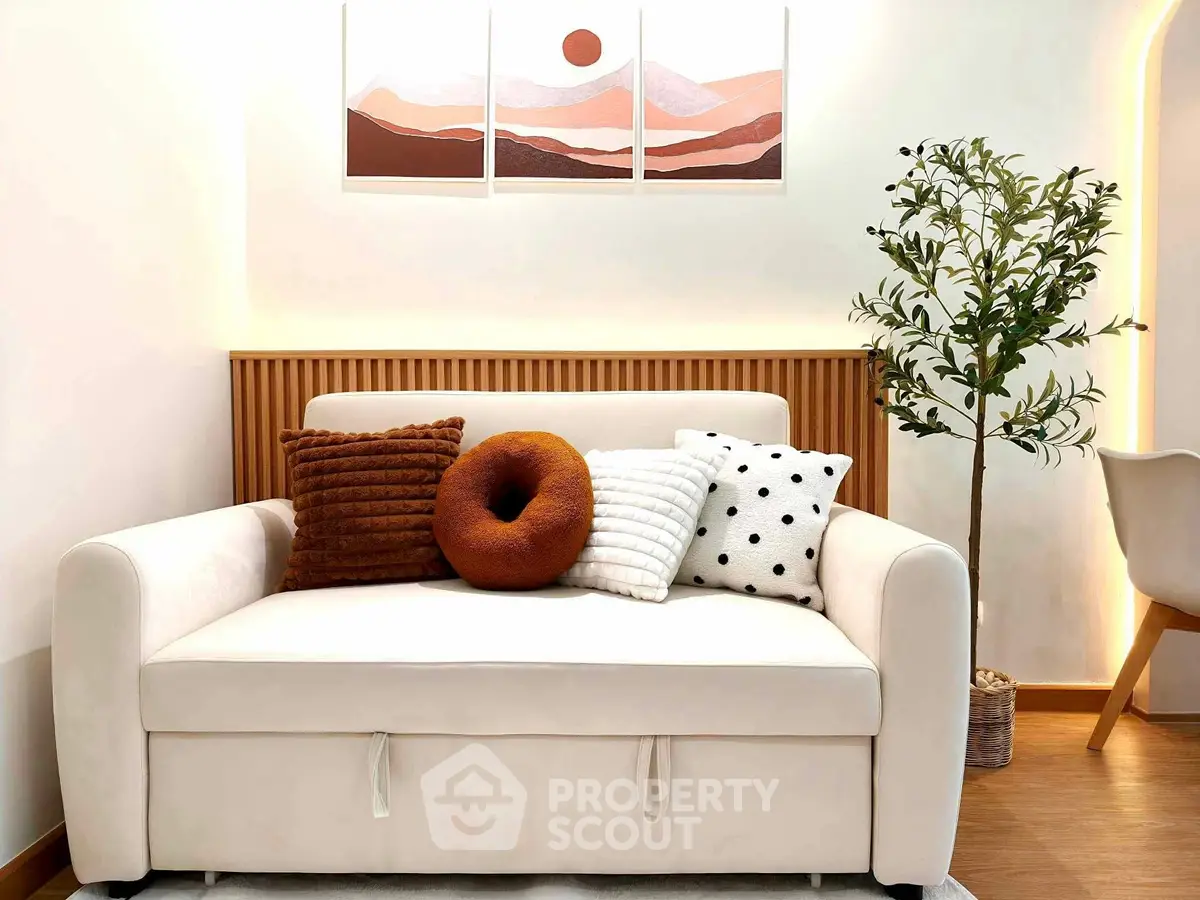 Cozy living room with stylish sofa and decorative pillows, perfect for modern interiors.