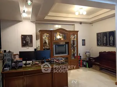 Spacious living room with elegant wooden furniture and decorative art pieces