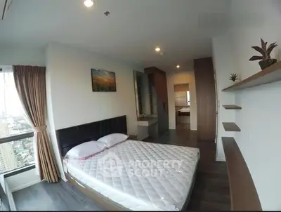 Spacious bedroom with city view in modern apartment