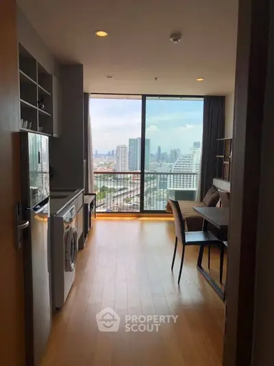 Modern apartment with city view, featuring open kitchen and dining area.