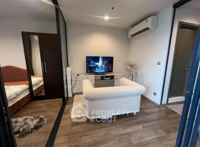 Modern living room with cozy sofa, TV, and air conditioning in stylish apartment.