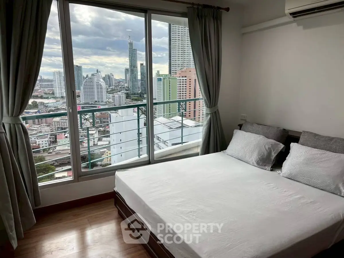 Modern bedroom with city view from large window, featuring cozy bed and air conditioning.