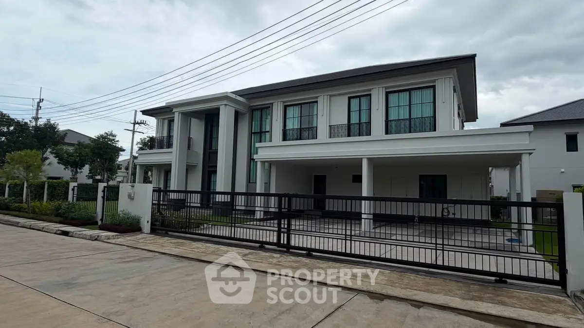 Luxurious modern two-story house with sleek design and spacious driveway in a serene neighborhood.