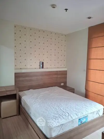 Spacious bedroom with modern wooden furniture and cozy ambiance.