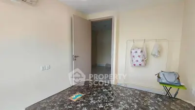 Cozy bedroom with open door and minimalistic decor, perfect for a serene living experience.