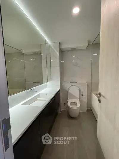 Modern bathroom with sleek design and large mirror