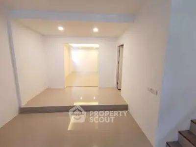 Spacious modern interior with sleek flooring and recessed lighting, ideal for versatile living space.