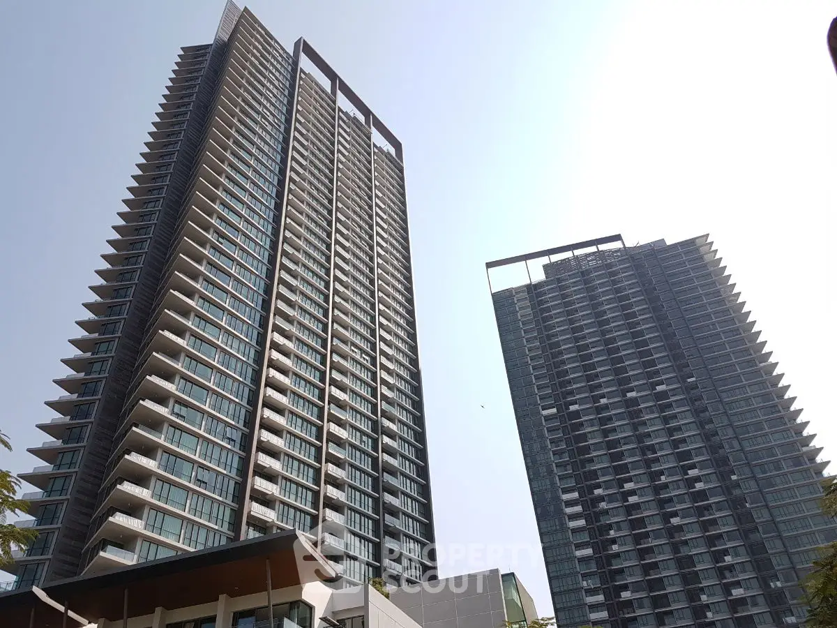 Modern high-rise residential buildings with sleek architecture and expansive balconies.