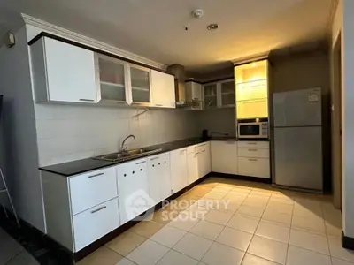 Spacious modern kitchen with sleek cabinetry and stainless steel appliances in a contemporary home.
