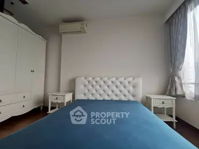 Elegant bedroom with plush headboard and natural light