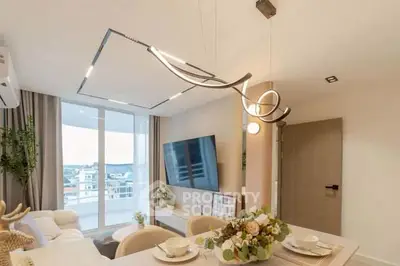 Modern living room with elegant lighting and balcony view