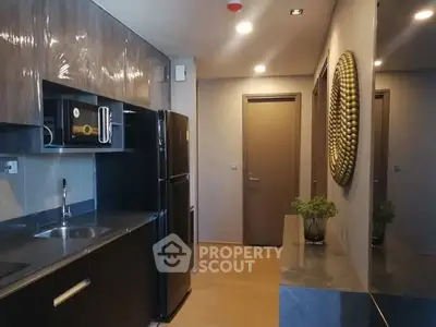 Modern kitchen with sleek cabinets and appliances in a stylish apartment