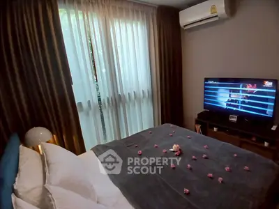 Cozy bedroom with modern decor, air conditioning, and a flat-screen TV for ultimate comfort.