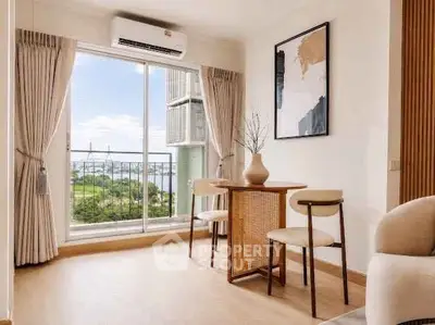 Bright living room with large window and scenic view, featuring modern furniture and elegant decor.