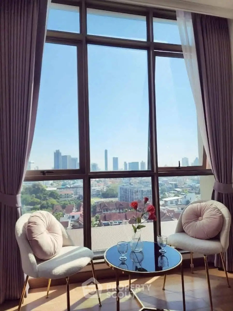 Stunning city view from elegant living room with chic furniture and large windows.