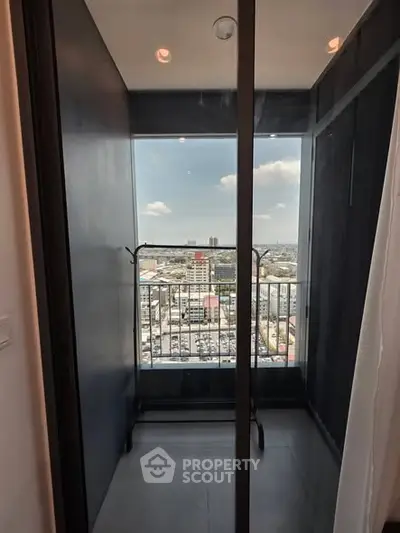Modern balcony with stunning city view and sleek glass railing, perfect for urban living.