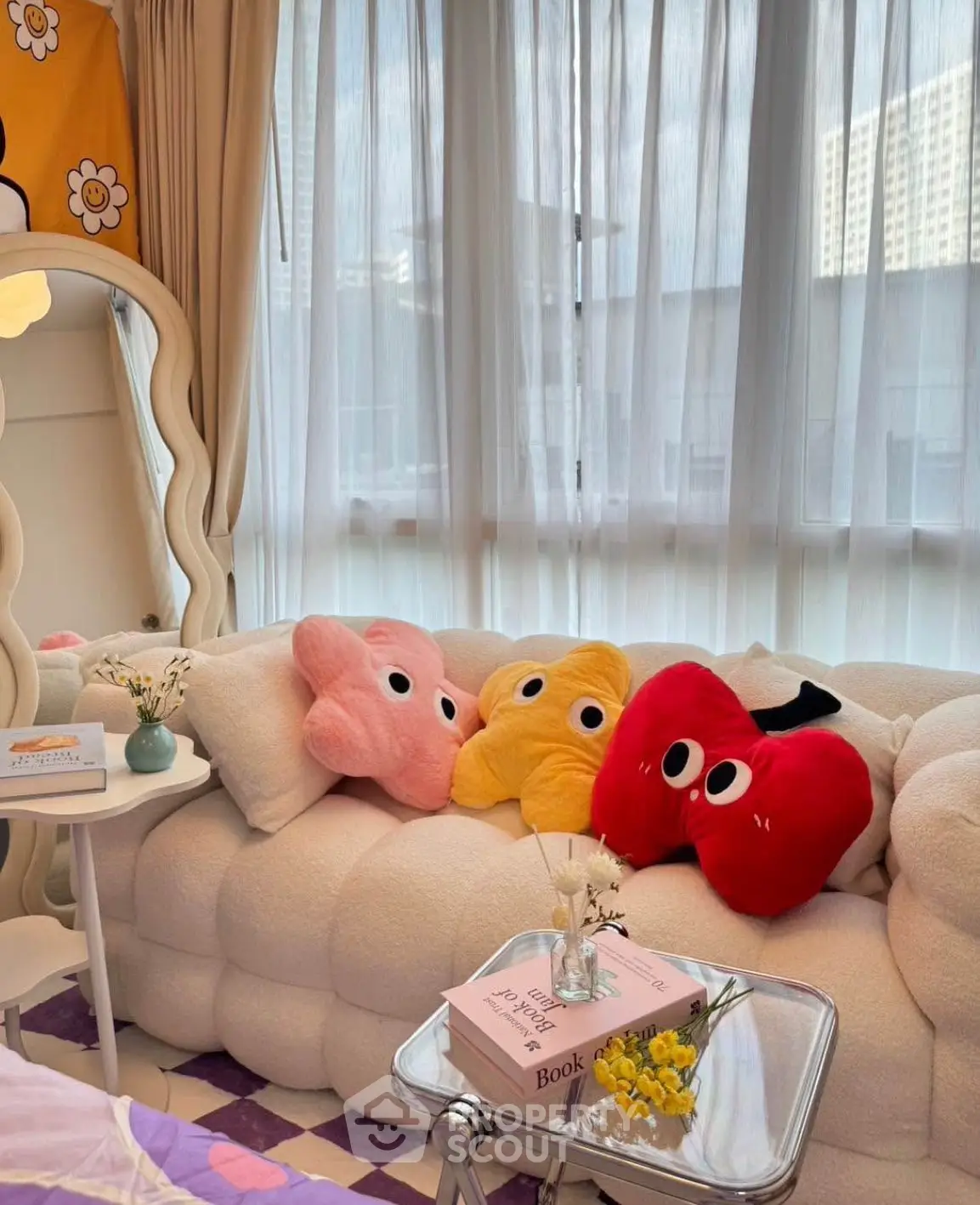 Charming living room with plush sofa and playful cushions, perfect for cozy relaxation.