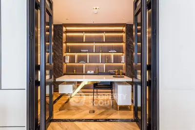 Modern kitchen with sleek design, featuring integrated appliances, marble flooring, and custom cabinetry with ambient lighting.