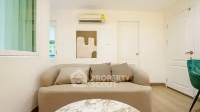 Cozy living room with modern sofa and stylish decor in a bright apartment.