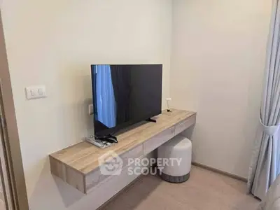 Modern minimalist living room with wall-mounted TV and sleek wooden console