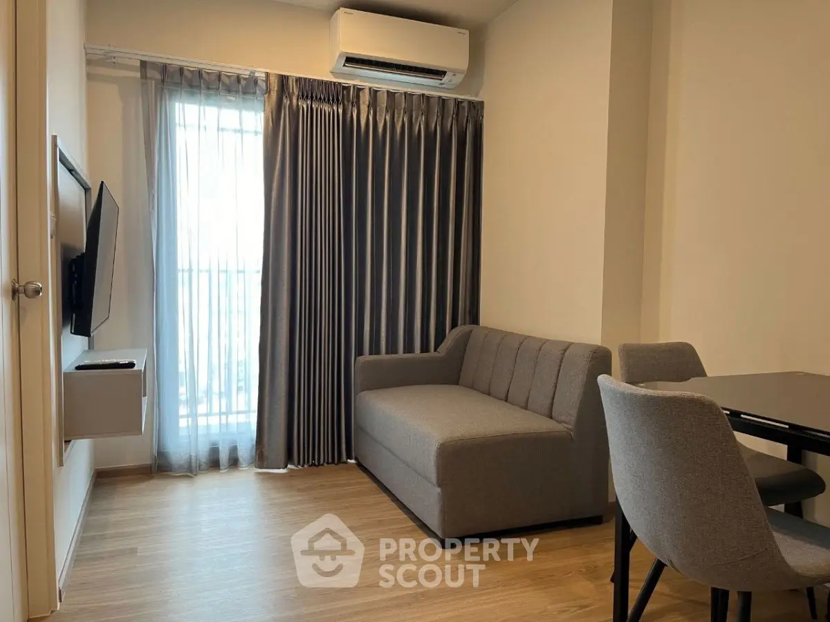 Modern living room with sleek furniture and natural light, perfect for urban living.