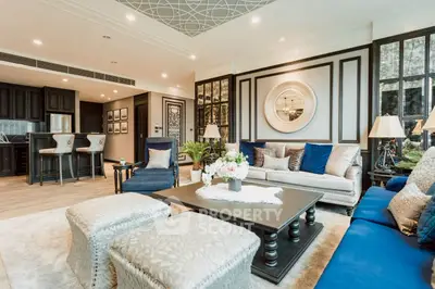 Luxurious living room with elegant decor and open kitchen layout, featuring plush seating and stylish lighting.