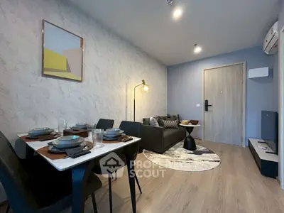 Modern living room with stylish decor and dining area in open layout apartment.