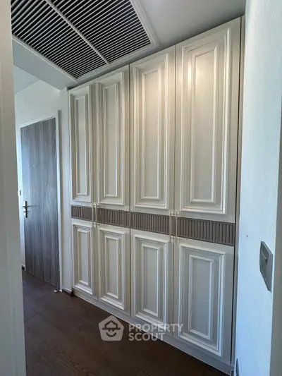 Elegant hallway with custom cabinetry and modern wood flooring