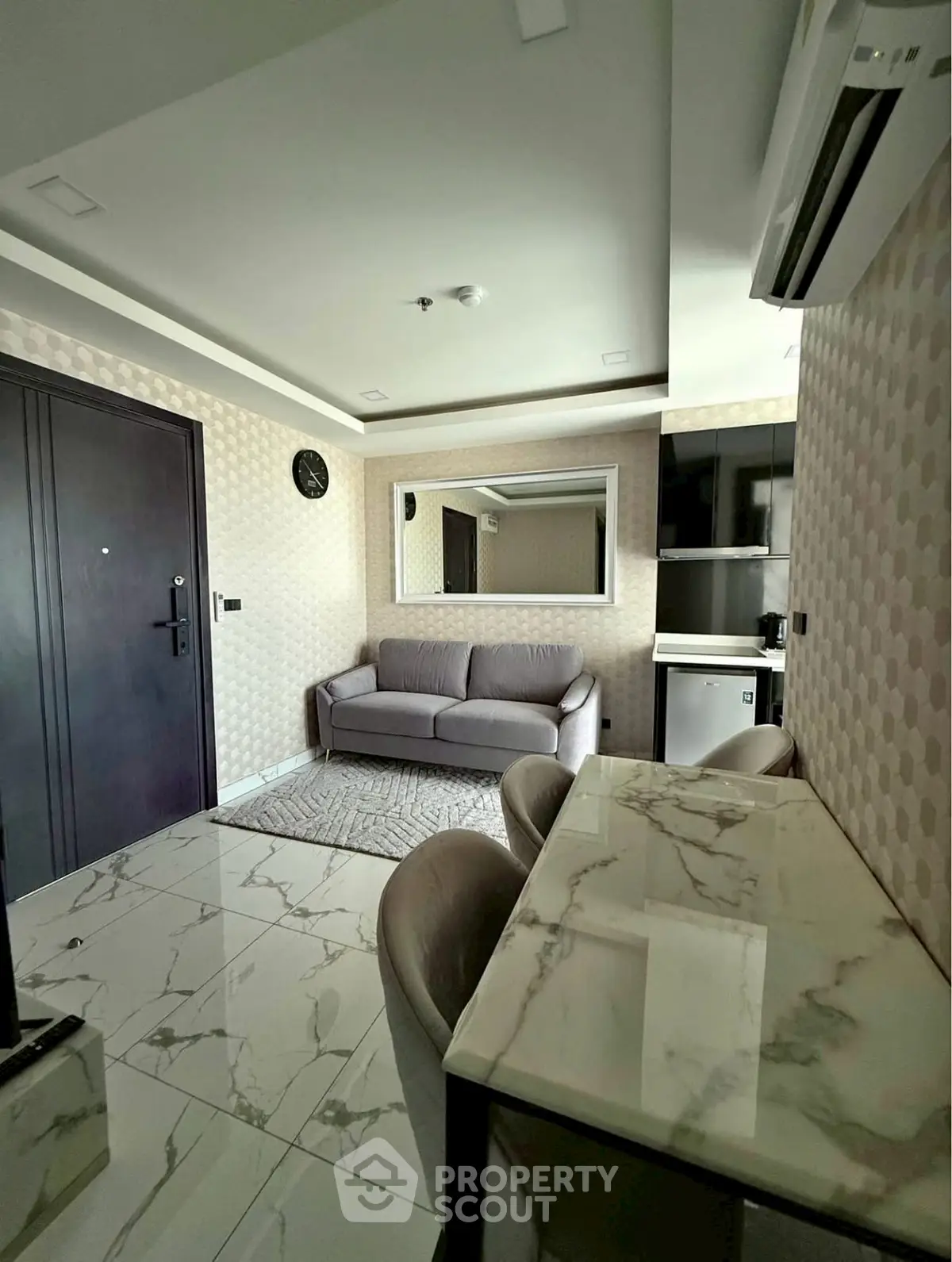 Modern living room with marble flooring and stylish furniture in a contemporary apartment.