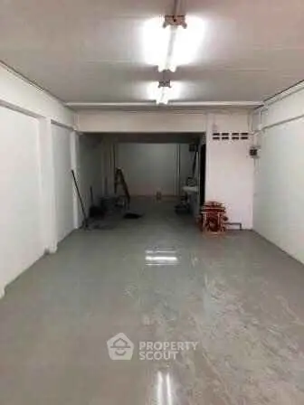 Spacious empty room with polished concrete floor and white walls, ideal for customization.