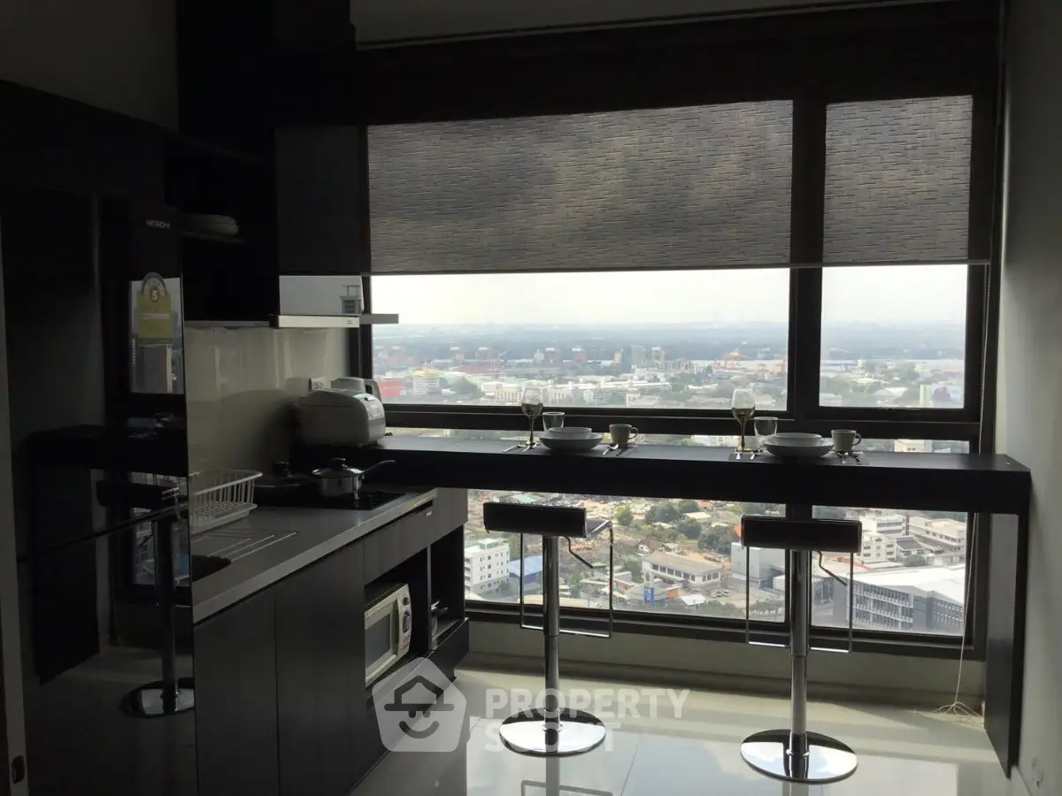 Modern kitchen with panoramic city view and sleek breakfast bar