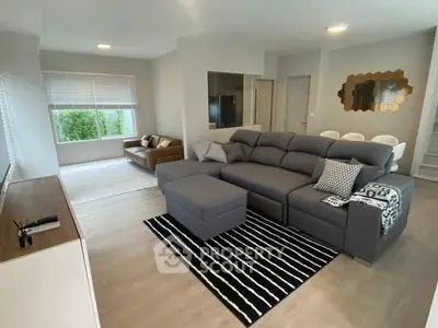 Spacious modern living room with stylish decor and ample natural light