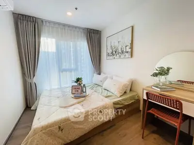 Cozy bedroom with stylish decor and natural light, perfect for relaxation and comfort.