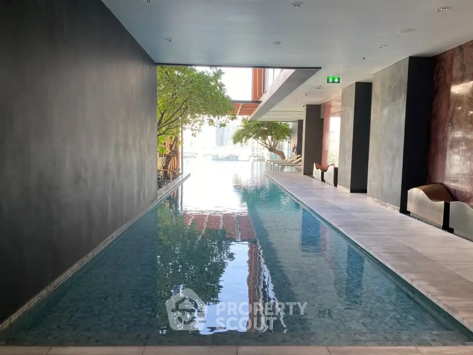 Luxurious indoor pool with modern design and city view, perfect for relaxation and leisure.