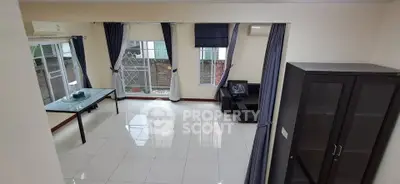 Spacious living room with large windows and modern furniture