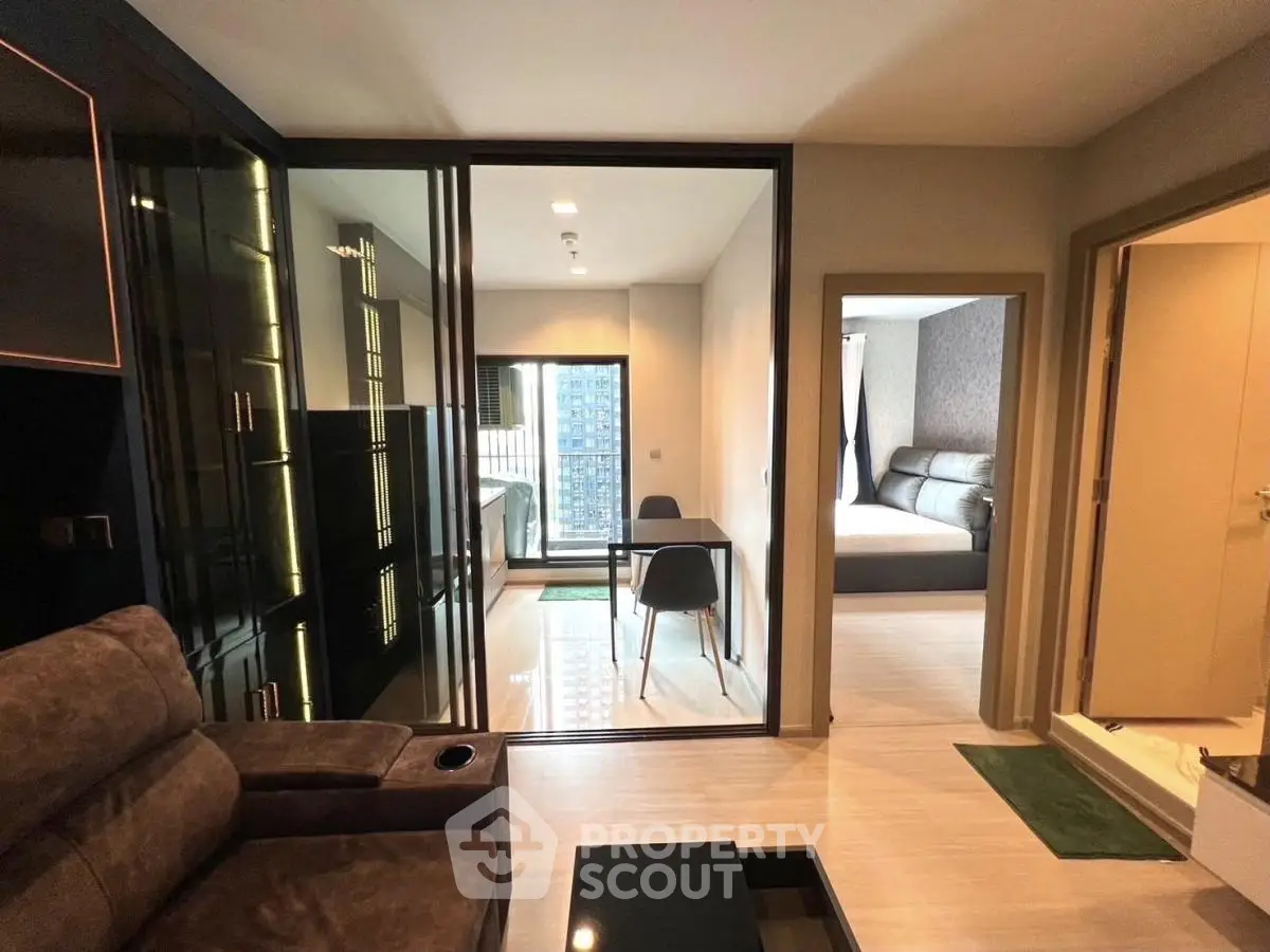 Modern apartment interior with living room, study area, and bedroom featuring sleek design and natural light.